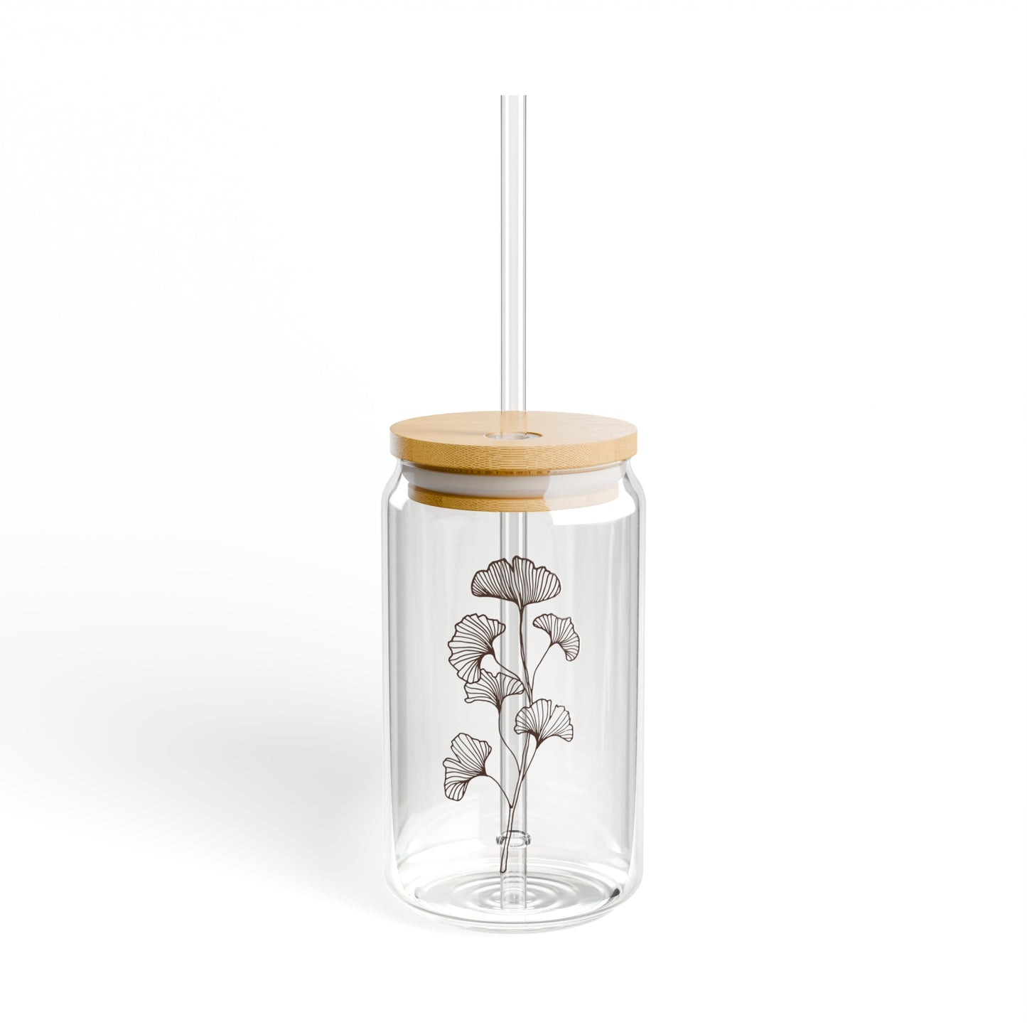 Image of glass drinking glass with spring flower, wood lid and and glass straw.