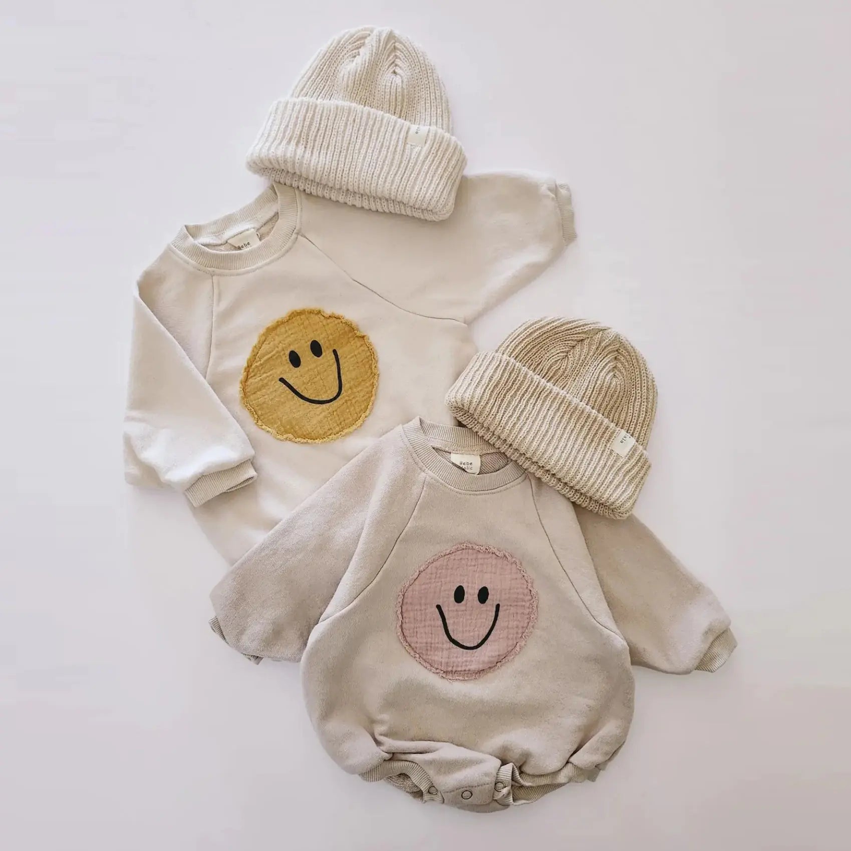 Smiley Face Sweatshirt Baby Romper will bring joy and laughter to your baby's wardrobe. With an adorable smiley face design, this romper is sure to make everyone smile. 